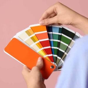 Hand looking through colour cards whilst studying Successful Interior Design course