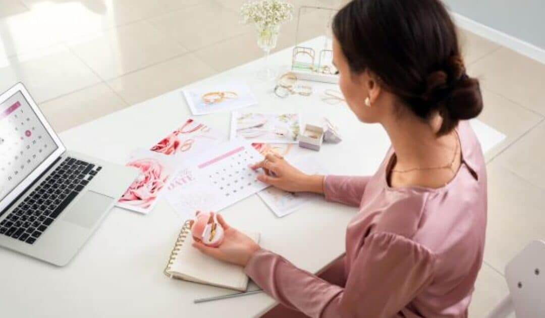 Woman sat at desk studying how to become a wedding planner or event planner course
